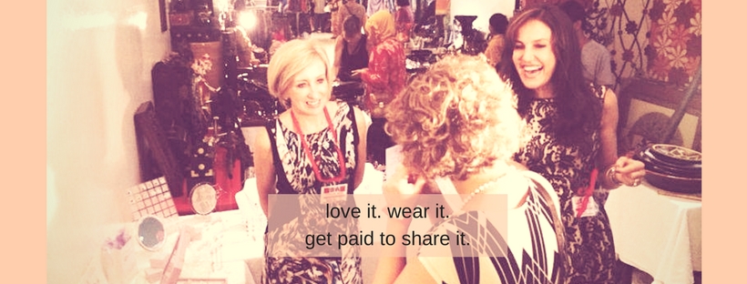lovely vibrant image with coral tones of smartly dressed women enjoying themselves selling jewelry