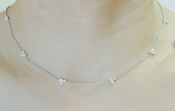 elegant piece features dainty diamond trios strung along a delicate Silver with 14K gold plated cable chain.