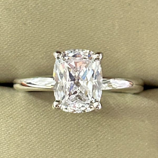 Solitaire Ring with 9x7mm cushion-cut lab-created diamond simulant in a four-prong setting, crafted in sterling silver with rhodium plating.