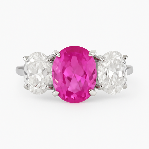 Ring with dark pink 8x10mm oval center stone and two 6x8mm diamond simulant ovals, prong-set in sterling silver with Rhodium Plating.